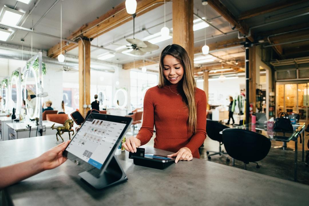 A woman using a tablet to complete a payment transaction, showcasing modern digital payment methods
